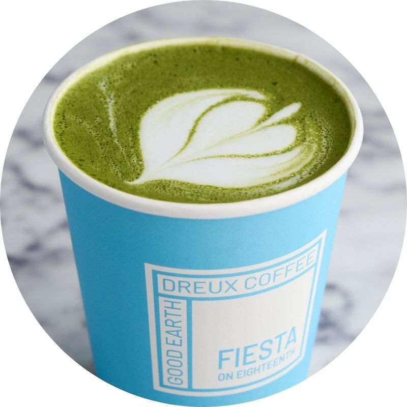 Matcha latte in a sky-blue Dreux Coffee cup
